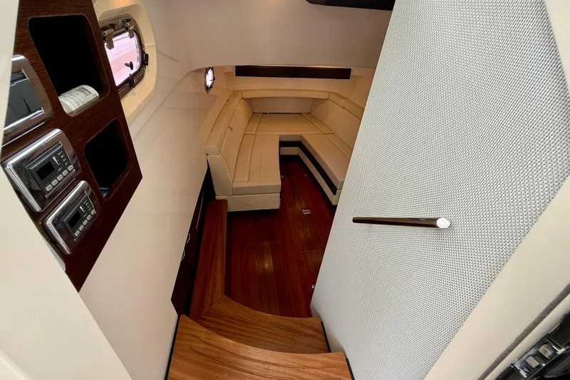Slide: The Image of Interior of 2018 Pursuit S 408 Sport boat with wooden flooring and plush seating. - 77