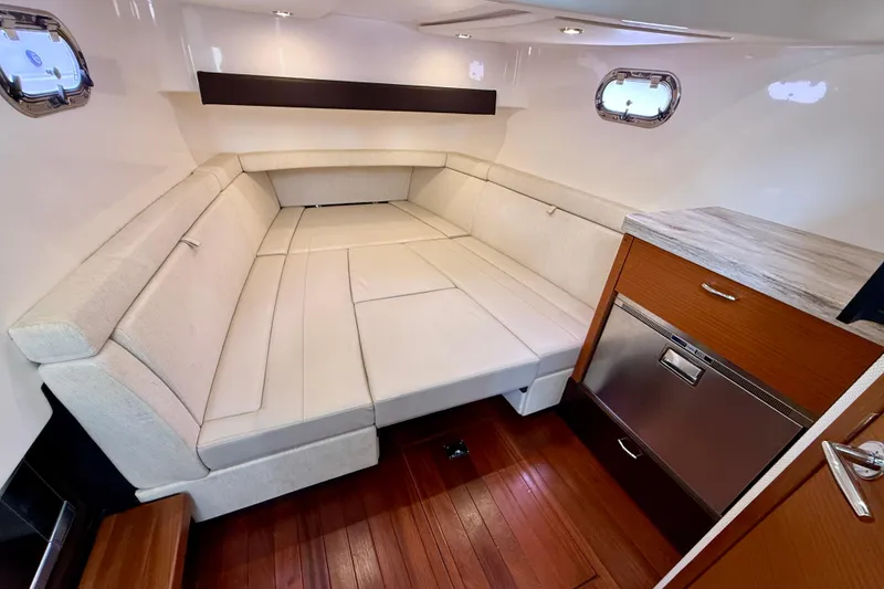 Slide: The Image of Luxurious interior of 2018 Pursuit S 408 Sport boat with plush seating and wooden accents. - 80