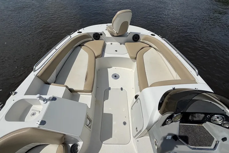 Slide: The Image of 2016 Stingray 192 SC boat interior with beige seating and sleek design on water. - 10