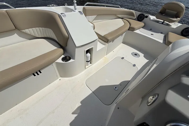 Slide: The Image of Interior of a 2016 Stingray 192 SC boat with beige seating and storage compartments. - 14