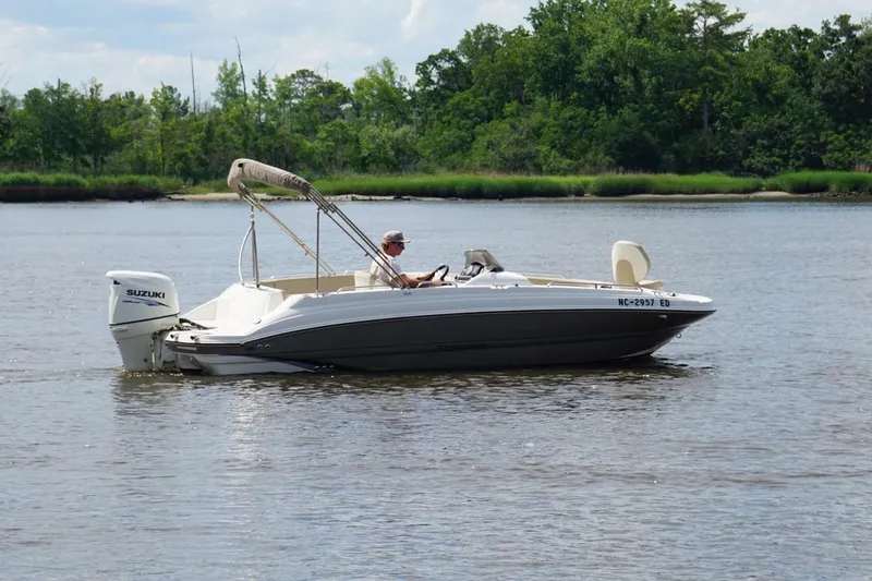 Slide: The Image of 2016 Stingray 192 SC boat with Suzuki outboard motor on a calm river. - 5