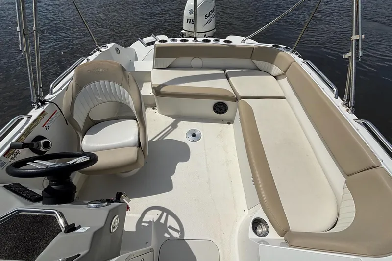 Slide: The Image of 2016 Stingray 192 SC boat interior with beige seating and steering wheel. - 9