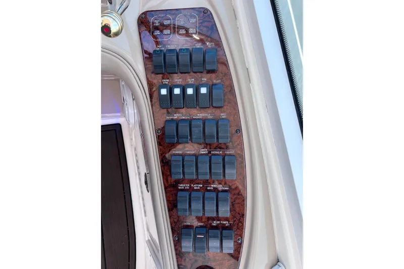 Slide: The Image of Control panel of a 2004 Sea Ray 500 Sundancer yacht with multiple switches. - 17