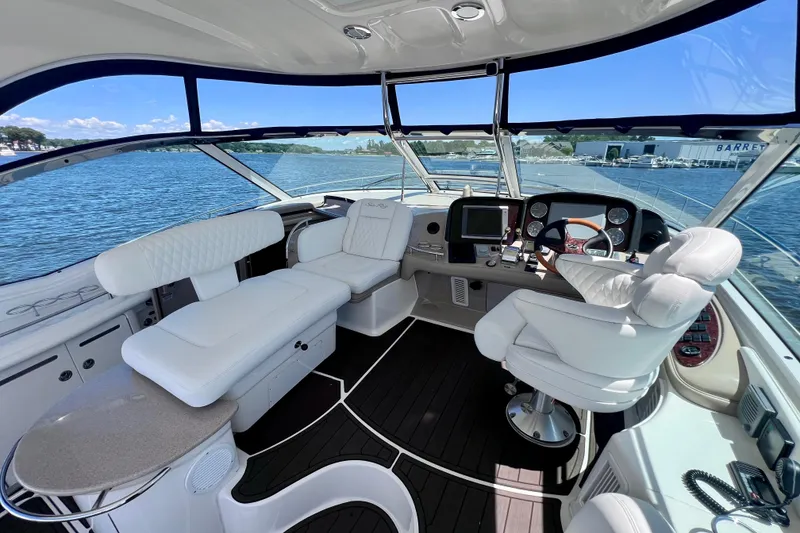 Slide: The Image of Luxurious 2004 Sea Ray 500 Sundancer yacht interior with plush seating and modern dashboard. - 19