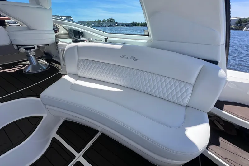 Slide: The Image of Luxurious interior of 2004 Sea Ray 500 Sundancer yacht with white seating and water view. - 21