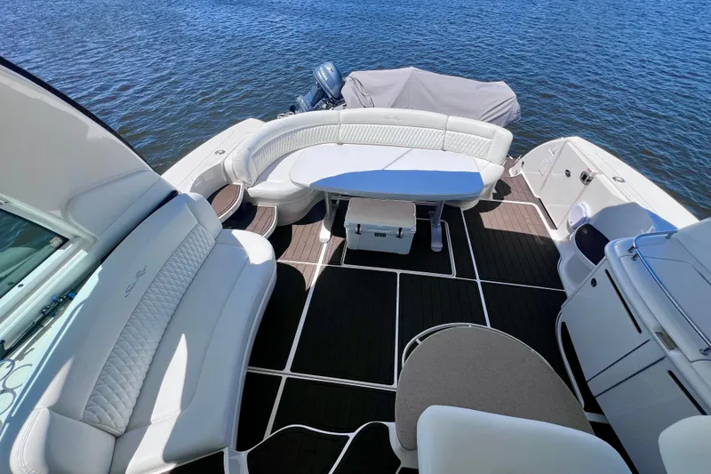 Slide: The Image of Luxurious 2004 Sea Ray 500 Sundancer yacht interior with elegant seating and table on the water. - 22