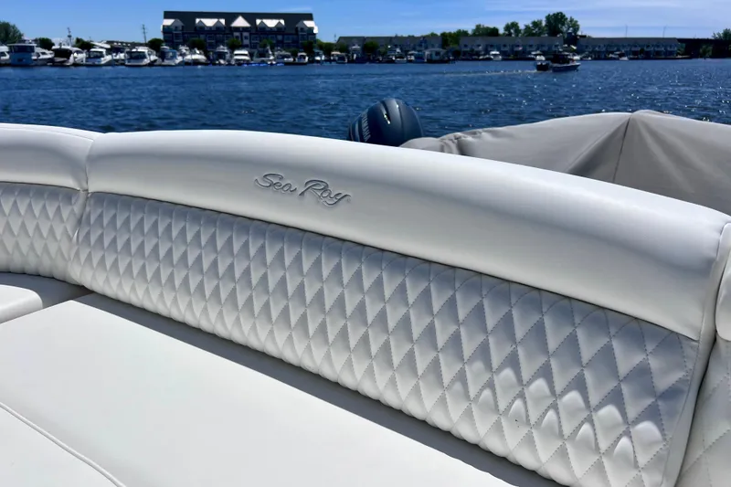 Slide: The Image of Luxurious white seating on a 2004 Sea Ray 500 Sundancer yacht, with waterfront view. - 23