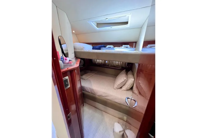 Slide: The Image of Interior cabin of 2004 Sea Ray 500 Sundancer yacht with bunk beds and wooden finish. - 30