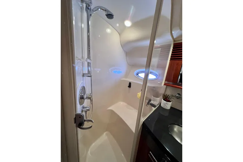 Slide: The Image of Luxurious bathroom in 2004 Sea Ray 500 Sundancer yacht with modern shower and porthole window. - 32