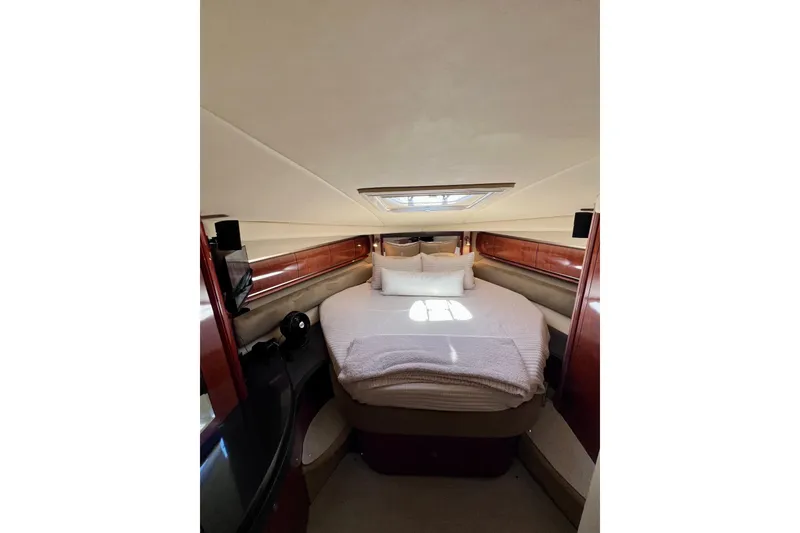 Slide: The Image of Luxurious cabin interior of 2004 Sea Ray 500 Sundancer yacht with cozy bed and elegant wood finish. - 33