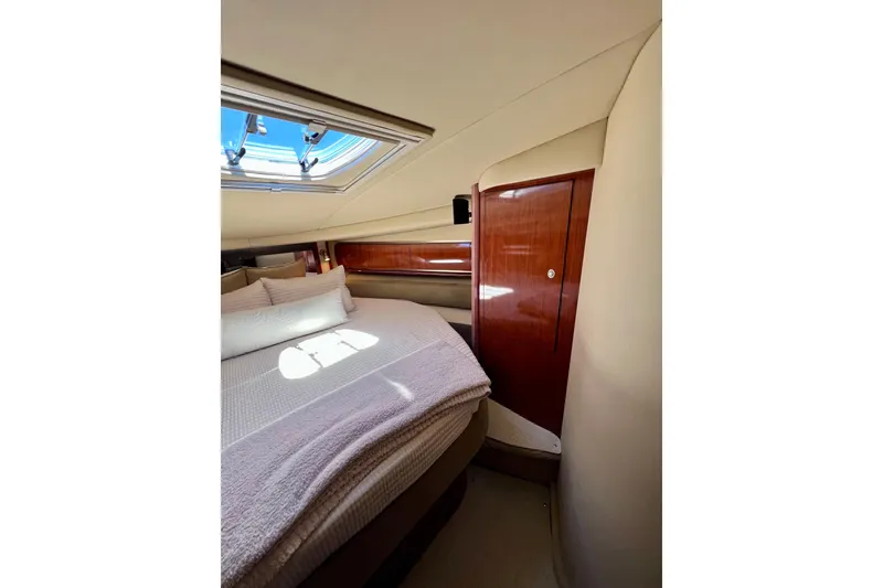Slide: The Image of Luxurious cabin interior of 2004 Sea Ray 500 Sundancer yacht with skylight and cozy bedding. - 34