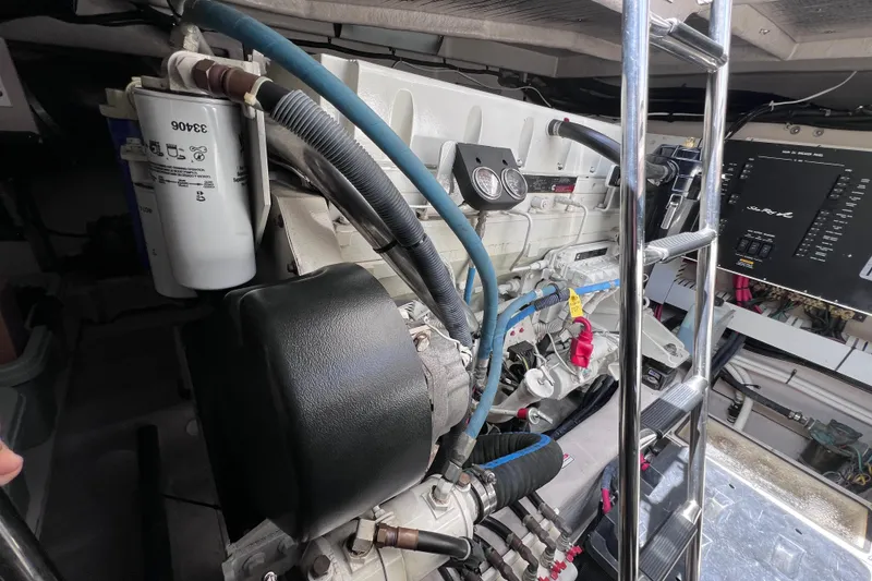 Slide: The Image of Engine room of a 2004 Sea Ray 500 Sundancer yacht, showcasing mechanical components and ladder. - 40