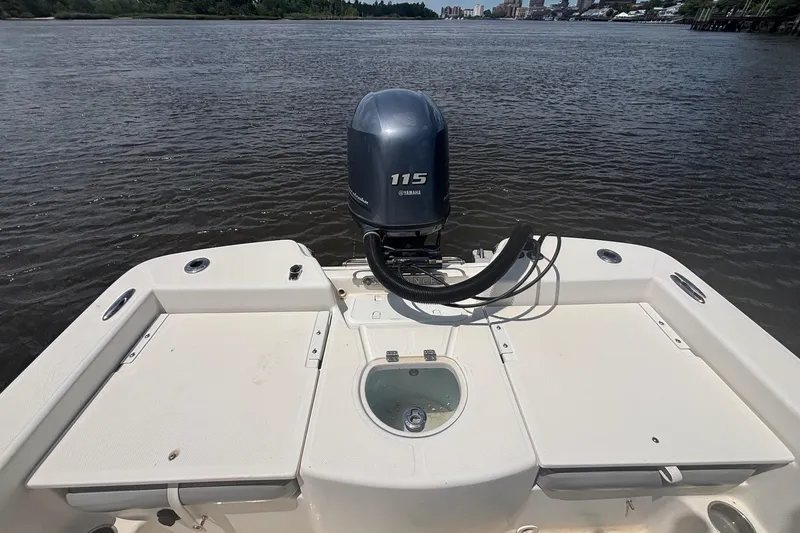 Slide: The Image of 2016 Sundance DX22 boat with Yamaha 115 engine on a calm river. - 11