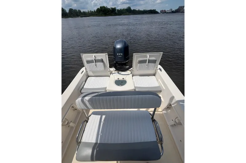Slide: The Image of 2016 Sundance DX22 boat with Yamaha 115 engine on calm water. - 12