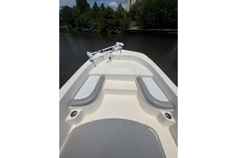 Slide: The Image of 2016 Sundance DX22 boat interior with seating, on calm water. - 13