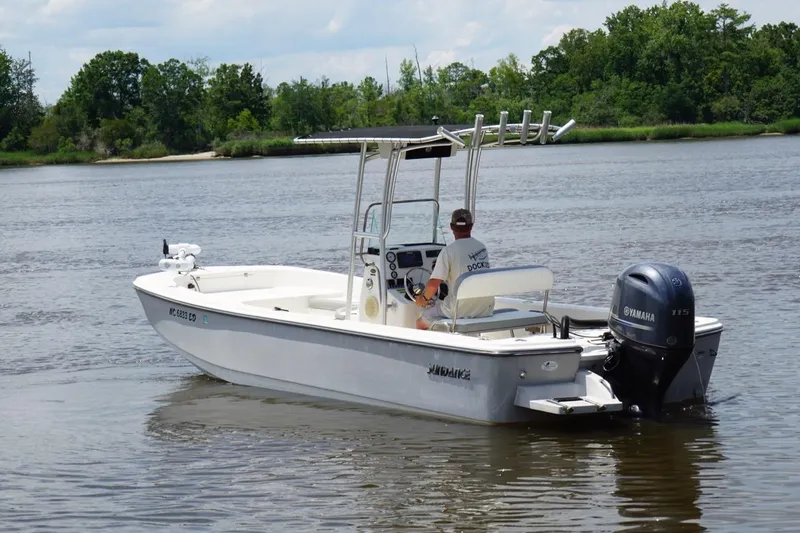 Slide: The Image of 2016 Sundance DX22 boat with Yamaha engine on a calm river. - 3