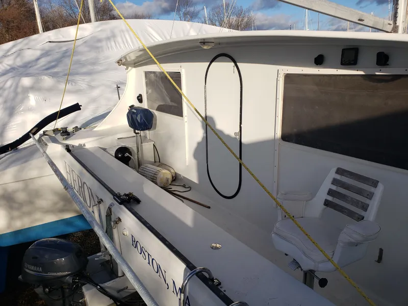 Slide: The Image of 2000 Crowther Catamaran docked, featuring a clean deck and seating area. - 11