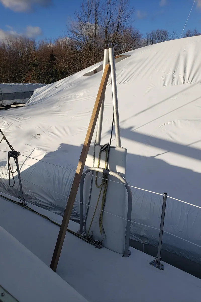 Slide: The Image of 2000 Crowther Catamaran covered in white tarp, docked outdoors under a clear sky. - 13
