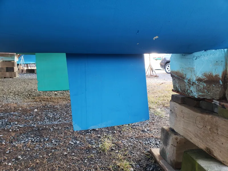 Slide: The Image of Blue Crowther Catamaran keel, 2000 model, on dry dock with wooden supports. - 14