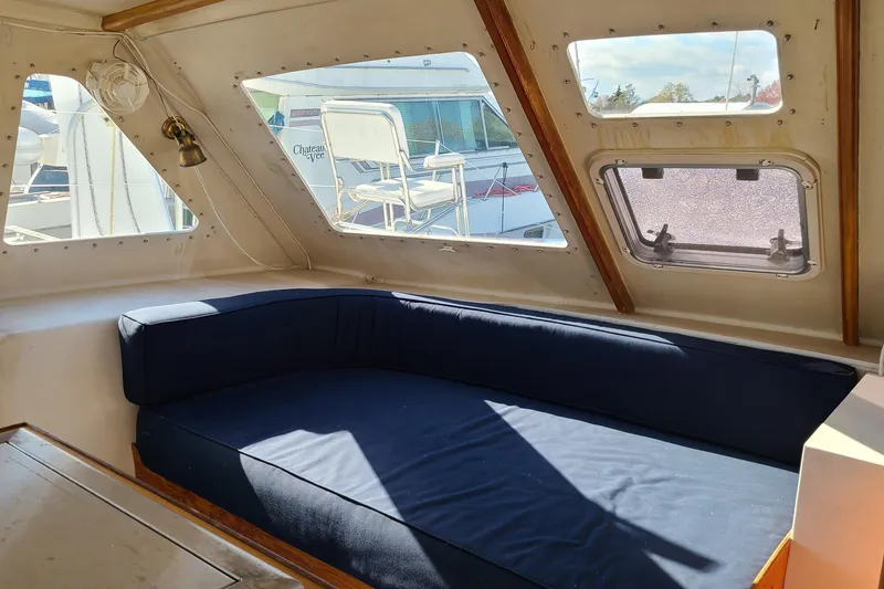 Slide: The Image of Interior of a 2000 Crowther Catamaran with blue seating and large windows. - 15
