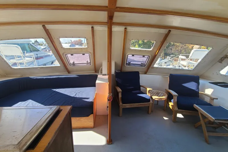 Slide: The Image of Interior of a 2000 Crowther Catamaran with blue seating and large windows. - 16