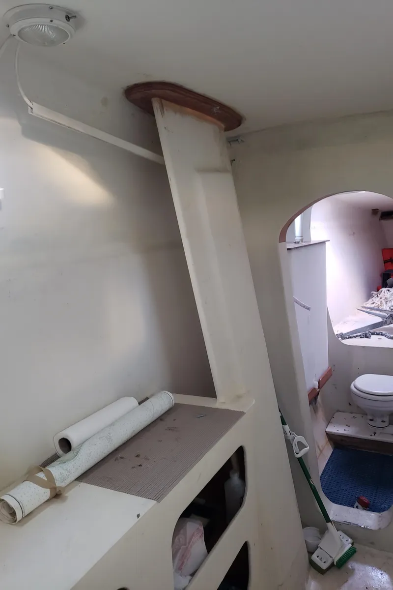 Slide: The Image of Interior of a 2000 Crowther Catamaran showing a cabin with storage and a bathroom. - 21