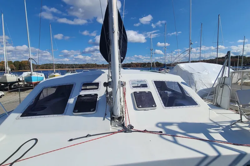 Slide: The Image of Crowther Catamaran 2000 docked under a clear blue sky with scattered clouds. - 5