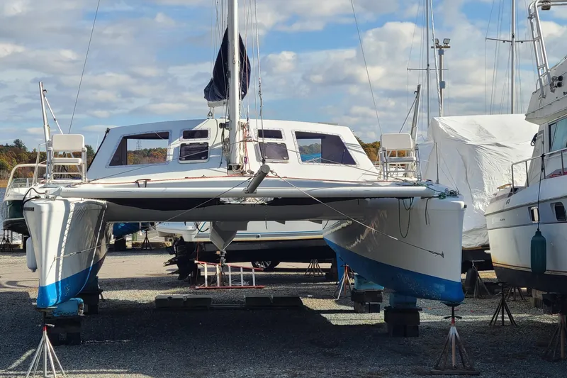 Slide: The Image of Crowther Catamaran 2000 on dry dock, surrounded by other boats under a partly cloudy sky. - 6