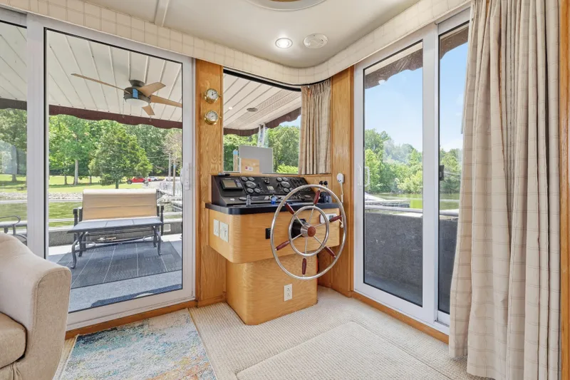 Slide: The Image of Helm area of a 2002 Sumerset 16x75 houseboat with scenic outdoor views. - 53