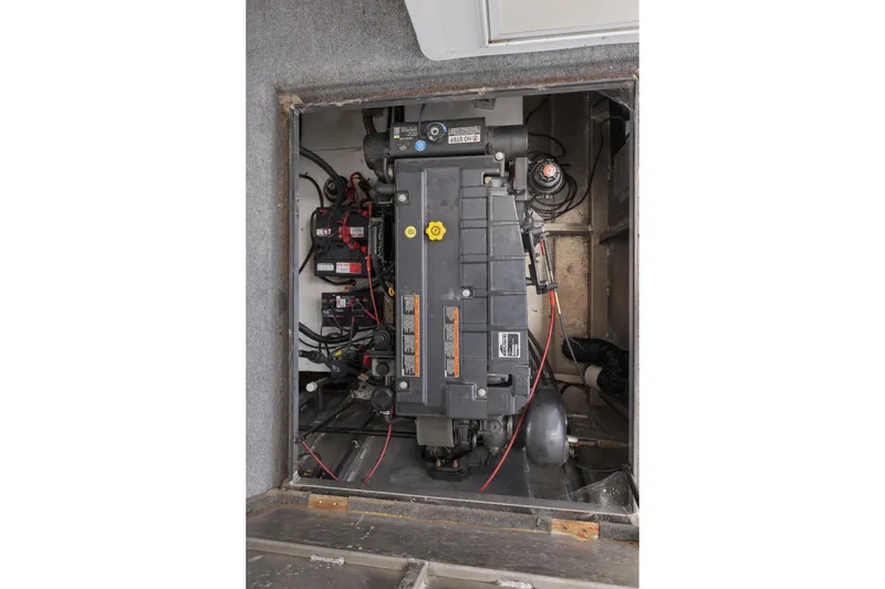 Slide: The Image of Engine compartment of a 2002 Sumerset 16x75 houseboat, showcasing mechanical components. - 43