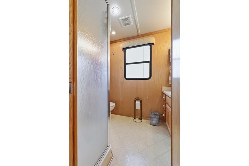 Slide: The Image of Bathroom interior of 2002 Sumerset 16x75 houseboat with shower and wooden cabinetry. - 76