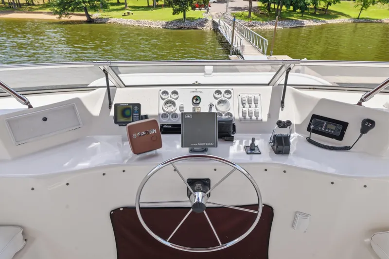 Slide: The Image of Helm of 2002 Sumerset 16x75 houseboat with steering wheel and navigation equipment. - 28