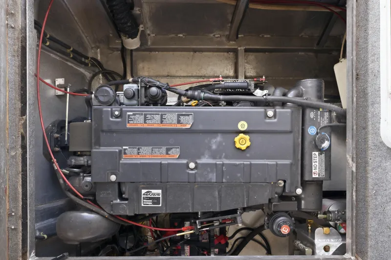 Slide: The Image of Engine compartment of a 2002 Sumerset 16x75 houseboat with visible engine and wiring. - 45