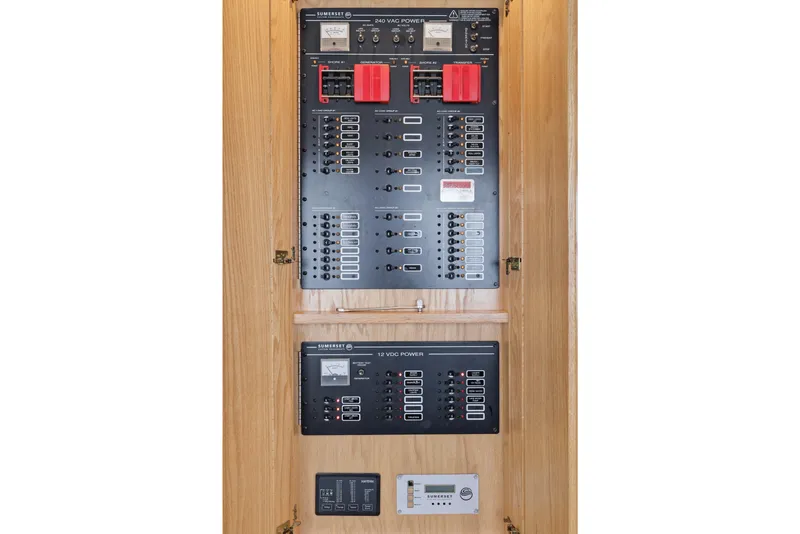 Slide: The Image of Electrical panel of a 2002 Sumerset 16x75 houseboat, featuring 240 VAC and 12 VDC controls. - 71