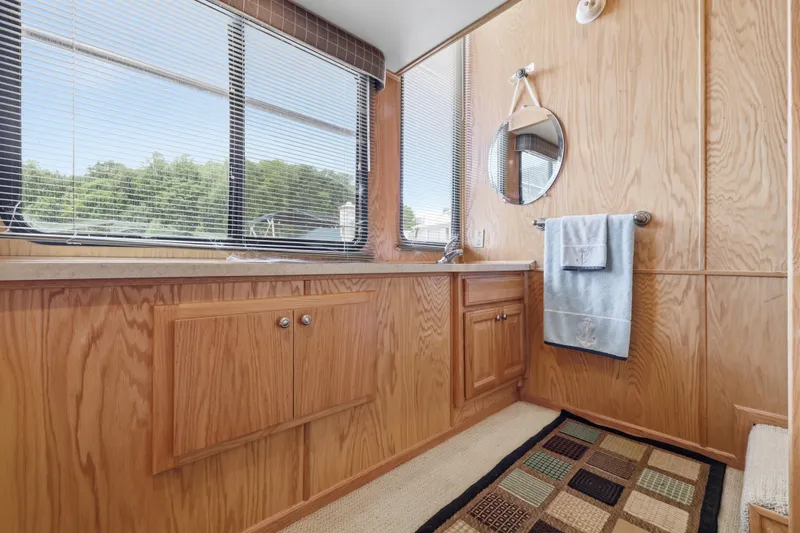 Slide: The Image of Luxurious 2002 Sumerset 16x75 houseboat bathroom with wood paneling and large windows. - 89