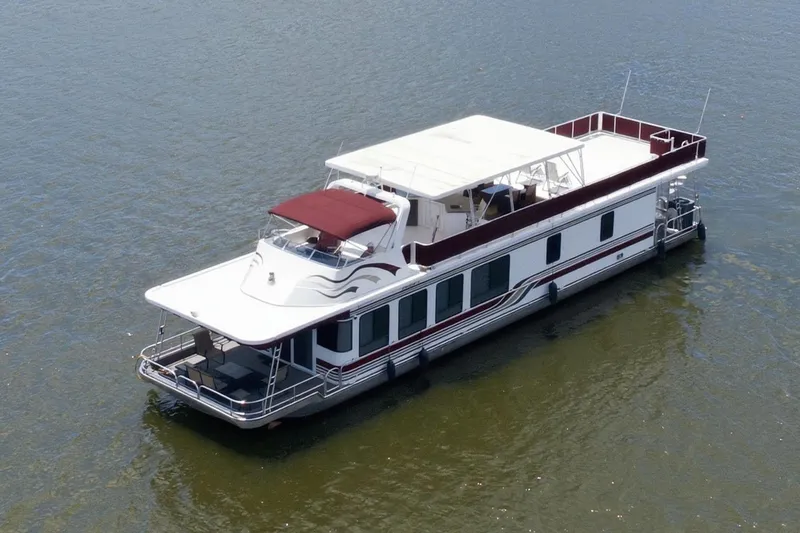 Slide: The Image of Houseboat on a serene lake, Sumerset 16x75, 2002 model, surrounded by lush greenery. - 15