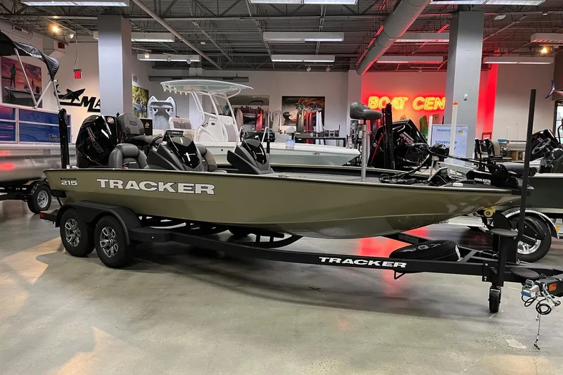 The Image of 2026 Tracker Savage 215 boat displayed indoors on a trailer at a showroom. - 0