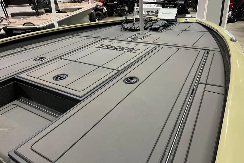 Slide: The Image of 2026 Tracker Savage 215 boat deck with storage compartments and Garmin equipment. - 7