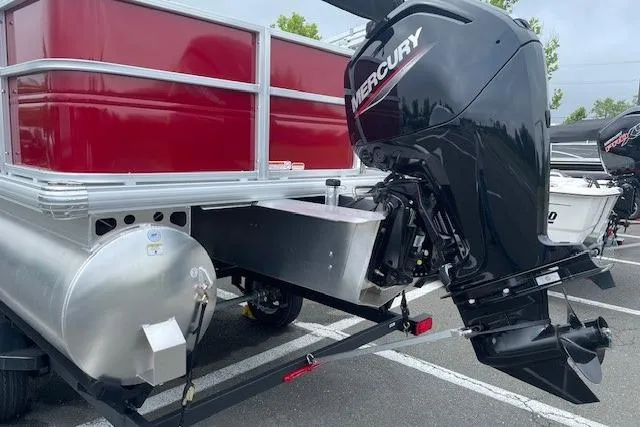 Slide: The Image of 2026 Sun Tracker Party Barge 18 DLX with Mercury outboard motor in parking lot. - 21