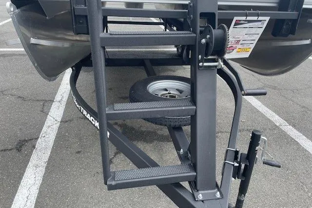 Slide: The Image of Trailer hitch and ladder of 2026 Sun Tracker Party Barge 18 DLX in parking lot. - 24