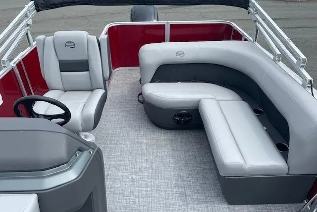 Slide: The Image of 2026 Sun Tracker Party Barge 18 DLX interior with gray seating and red accents. - 18