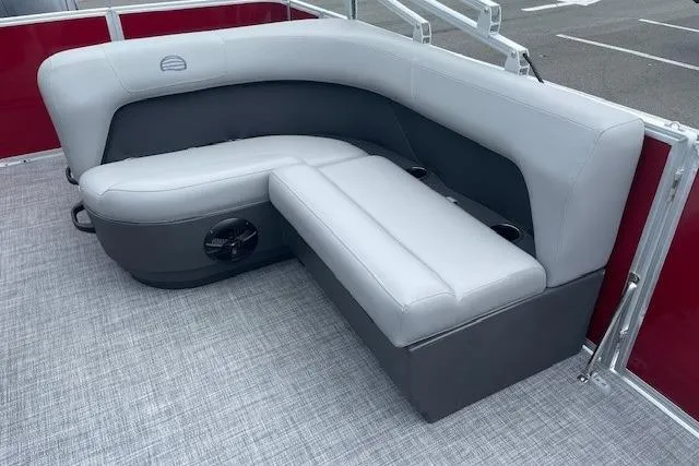 Slide: The Image of 2026 Sun Tracker Party Barge 18 DLX interior with gray seating and cup holders. - 13