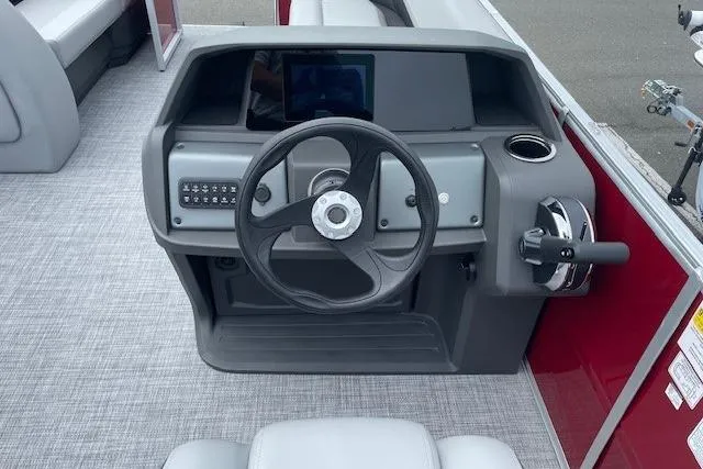 Slide: The Image of 2026 Sun Tracker Party Barge 18 DLX dashboard with steering wheel and controls. - 16