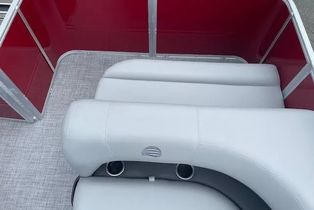 Slide: The Image of 2026 Sun Tracker Party Barge 18 DLX interior with gray seating and red paneling. - 14
