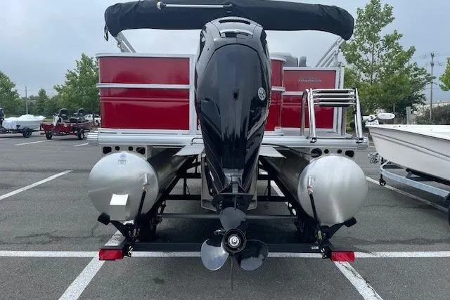 Slide: The Image of 2026 Sun Tracker Party Barge 18 DLX pontoon boat with outboard motor in parking lot. - 22