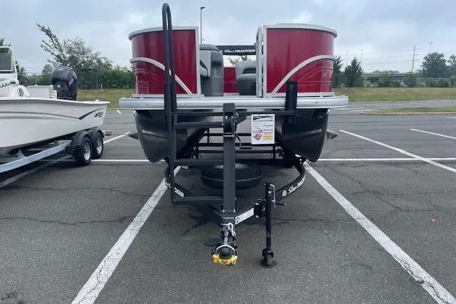 Slide: The Image of 2026 Sun Tracker Party Barge 18 DLX pontoon boat on trailer in parking lot. - 17