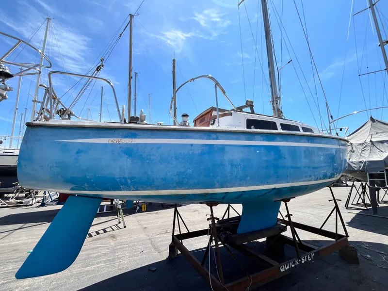 Slide: The Image of 1974 Capital Newport 30 MKII sailboat on a dry dock. - 1