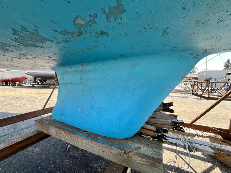 Slide: The Image of Underside of a 1974 Capital Newport 30 MKII on a stand. - 4