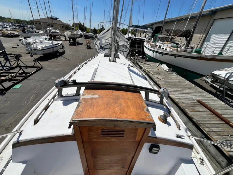 Slide: The Image of 1974 Capital Newport 30 MKII sailboat docked in harbor. - 5
