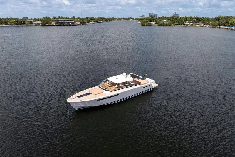 Slide: The Image of 2023 Delta Powerboats 60 Open yacht cruising on a serene waterway. - 13